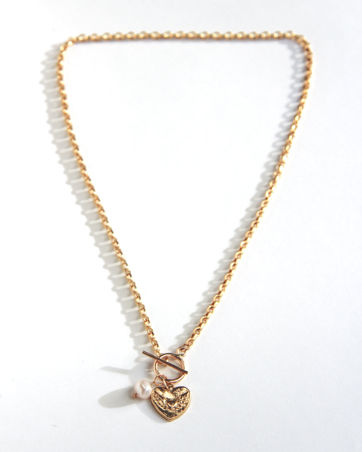 Gold-filled toggle necklace with a heart charm and pearl drop